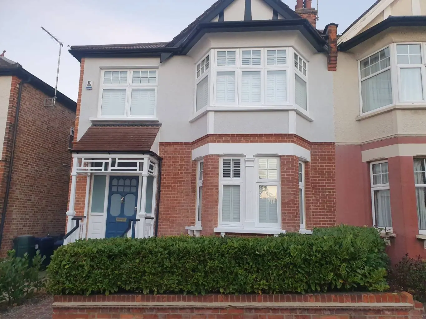 A semi-detached house finished in white silicone render, High Barnet